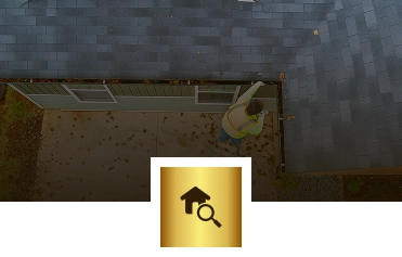 A person in a yellow safety vest inspects the edge of a roof on a house, seen from above. Scattered leaves cover the roof and ground below. The Exterior Done Best icon featuring a house and magnifying glass is overlaid at the bottom center.