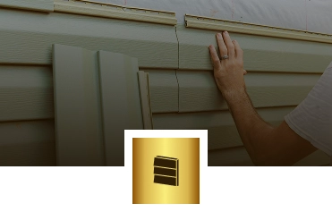 A person’s hand installs beige vinyl siding panels on a house exterior. A gold icon with three horizontal lines, resembling siding, overlays the bottom center—showcasing why Exterior Done Best is trusted in the Twin Cities for expert exterior and roofing services.